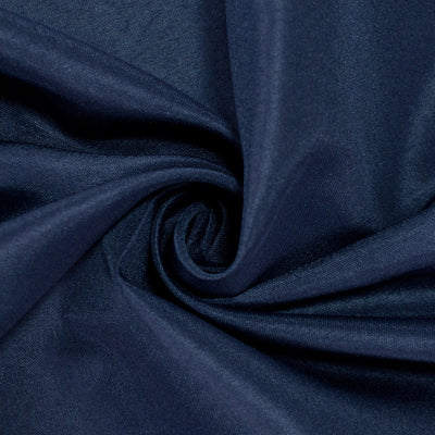 Navy blue fabric with smooth texture, twisted in a circular pattern. #whtbkgd