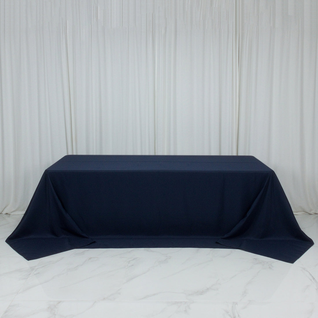 Navy tablecloth on a table in a studio setting