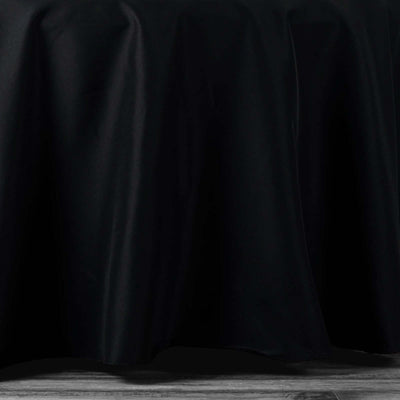Black tablecloth draping elegantly over a table edge.