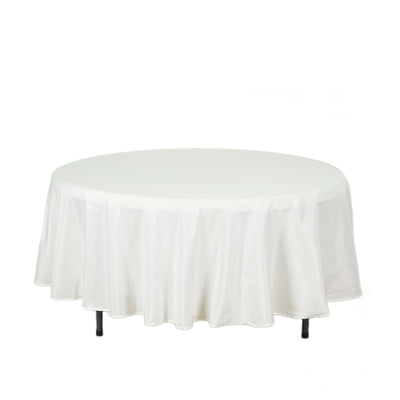 Round white tablecloth with pleated edges.