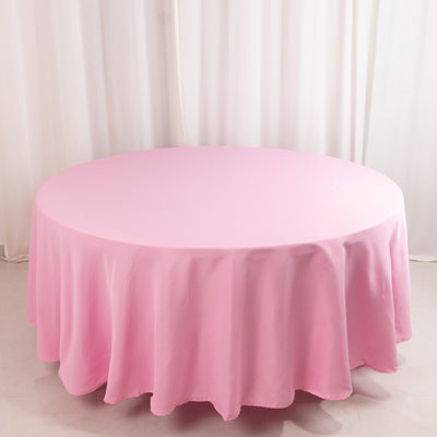 Round pink tablecloth draped elegantly over a table.