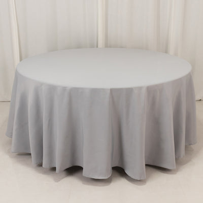 Gray round tablecloth draping over a circular table.