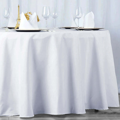 Elegant white tablecloth draping a table set for dining.