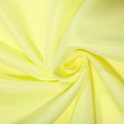 Bright yellow fabric swirl, showcasing smooth texture and vibrant color.
