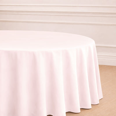 Round pink tablecloth draping over a circular table.
