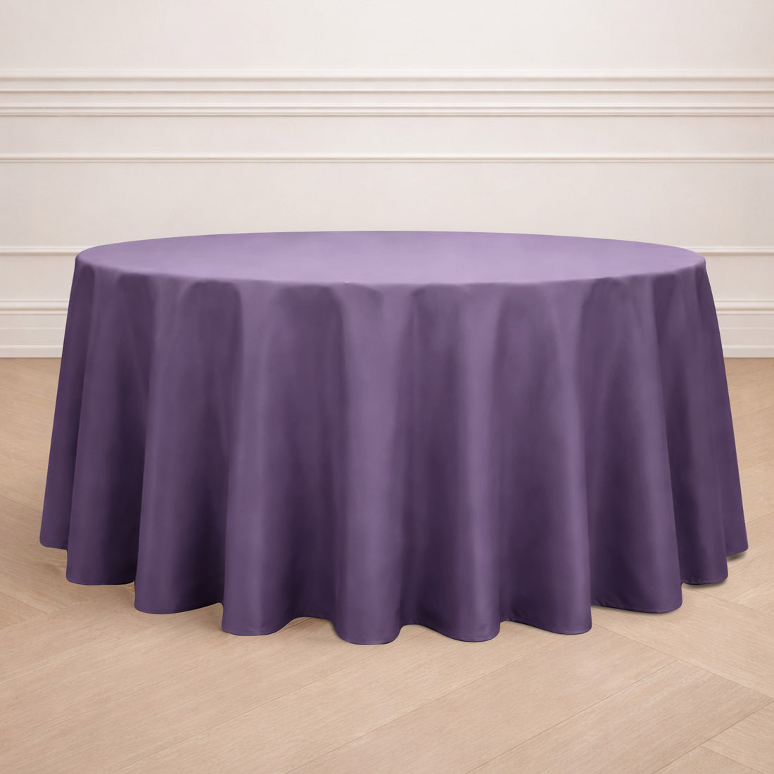 Round purple tablecloth on a wooden floor.