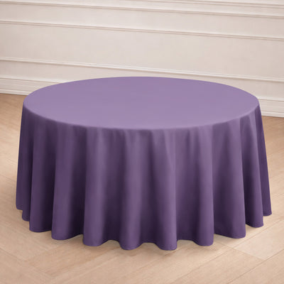 Purple round tablecloth on a wooden floor.