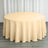 Round beige tablecloth draped over a table in a staged setting.