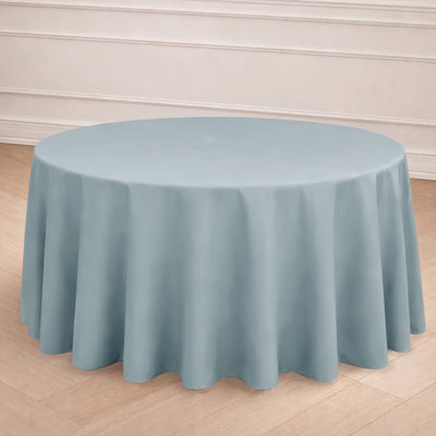 Round blue tablecloth on a wooden floor backdrop.