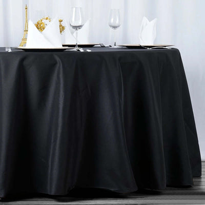 Elegant black tablecloth draping a table set for dining.