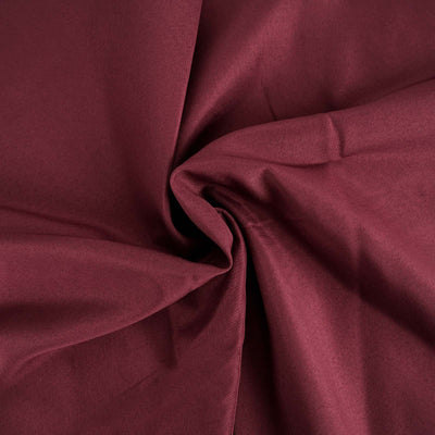 Burgundy fabric draped, showcasing soft texture and rich color.