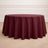 Round burgundy tablecloth on a wooden floor