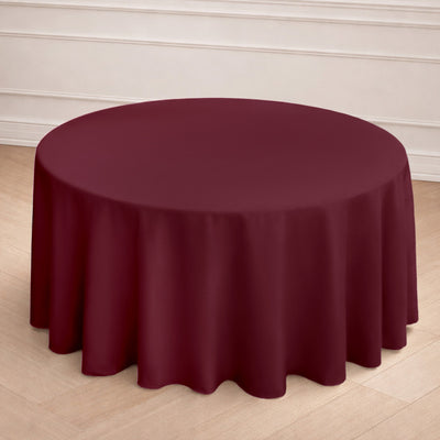 Round burgundy tablecloth elegantly draped over a table