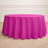 Round pink tablecloth draped over a table set with plates and glasses.