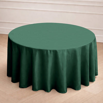 Round green tablecloth on a wooden surface.