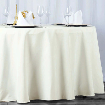 Elegant cream tablecloth draping a table set for a formal dining experience.