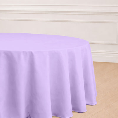 Purple round tablecloth draped over a table in a styled setting.