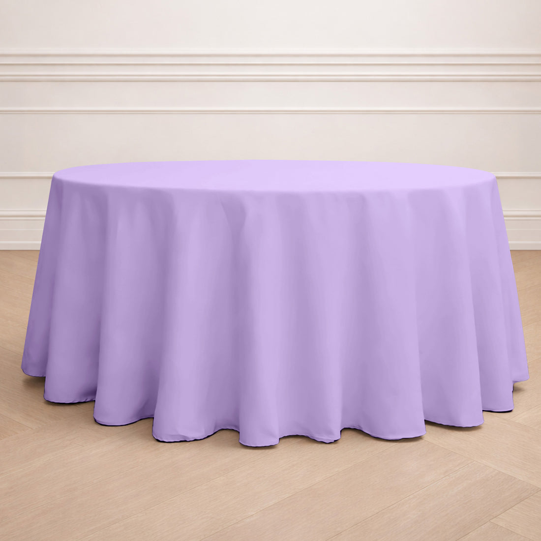 Round lavender tablecloth on a wooden floor.