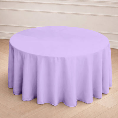 Round lavender tablecloth draped over a table in an indoor setting.