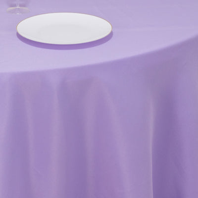 Purple tablecloth with a white plate on a dining table.