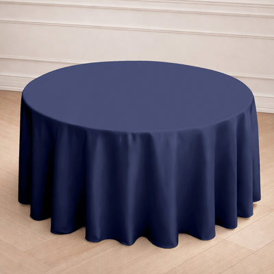 Navy round tablecloth draped elegantly on a wooden table.