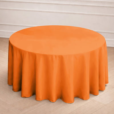 Orange round tablecloth draped elegantly over a table.