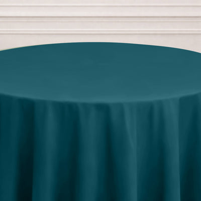 Teal round tablecloth on a neutral background.