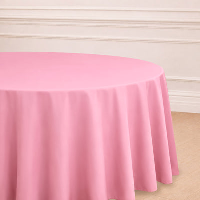 Round pink tablecloth draped elegantly over a table.