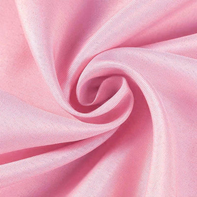 Soft pink fabric swirl close-up showing texture and sheen.#whtbkgd