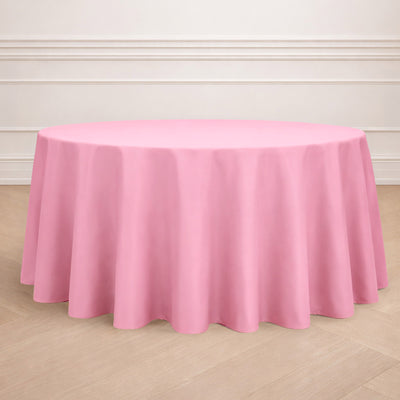 Round pink tablecloth draped elegantly over a circular table.