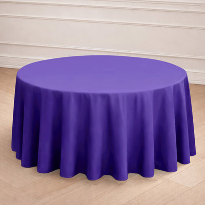 Purple round tablecloth on a wooden floor.