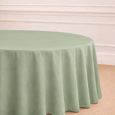 Round sage green tablecloth with elegant drape.