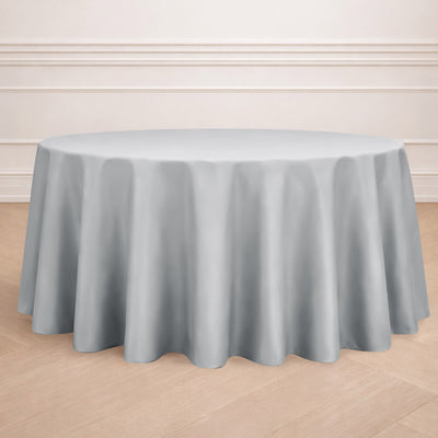 Round gray tablecloth on a wooden floor.