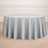 Round gray tablecloth on a wooden floor.