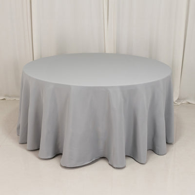 Round gray tablecloth draped elegantly over a circular table.