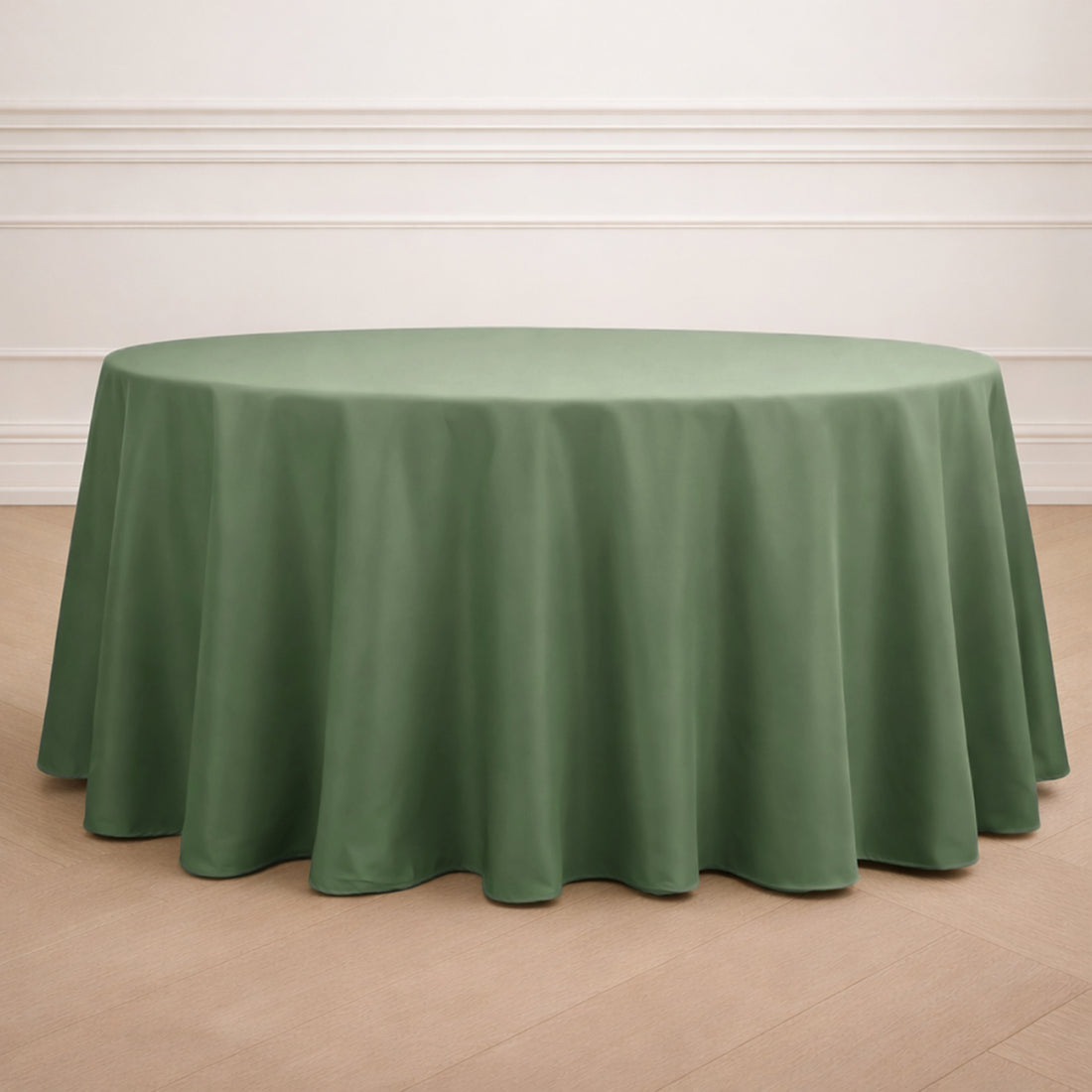 Round green tablecloth on a wooden floor with a light background.