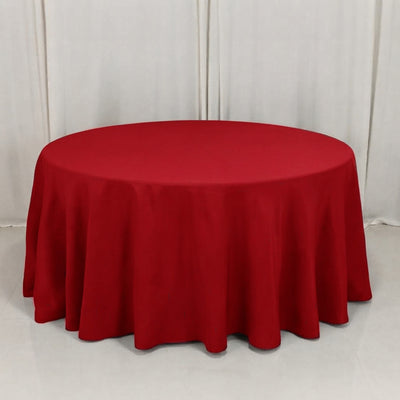 Round table with red tablecloth on a white backdrop