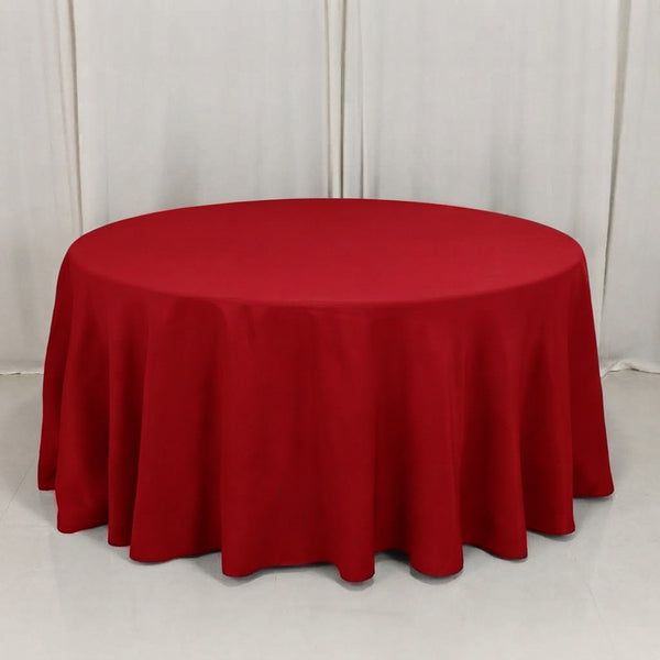 Round table with red tablecloth on a white backdrop
