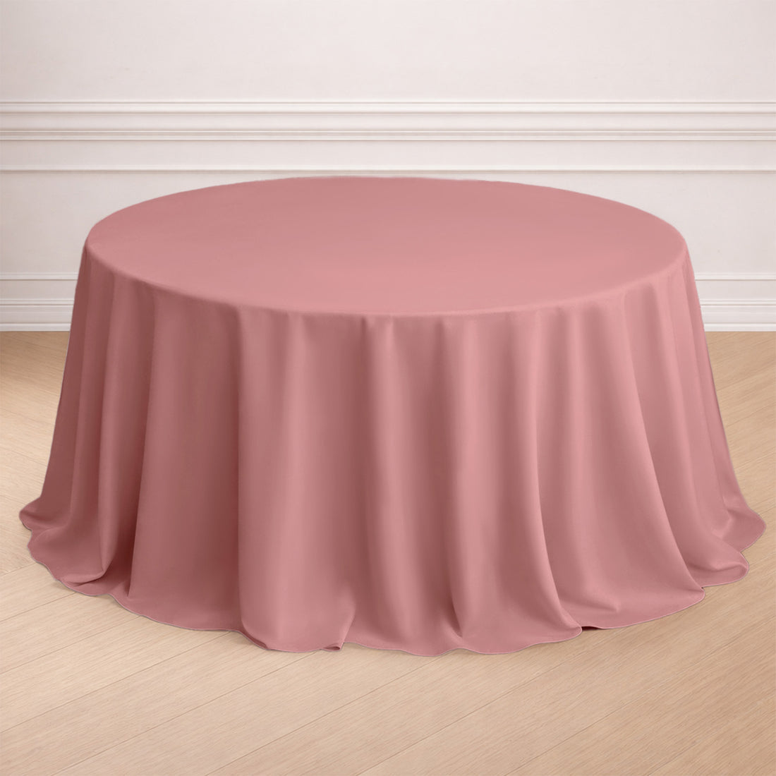 Round pink tablecloth draped elegantly over a table.