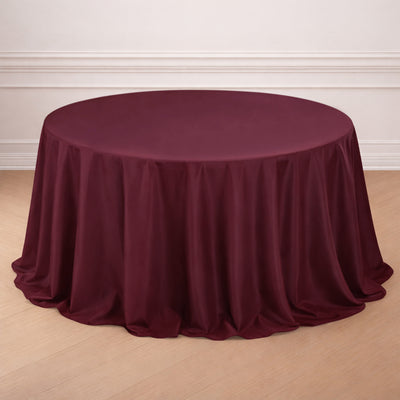 Round burgundy tablecloth draped elegantly over a table