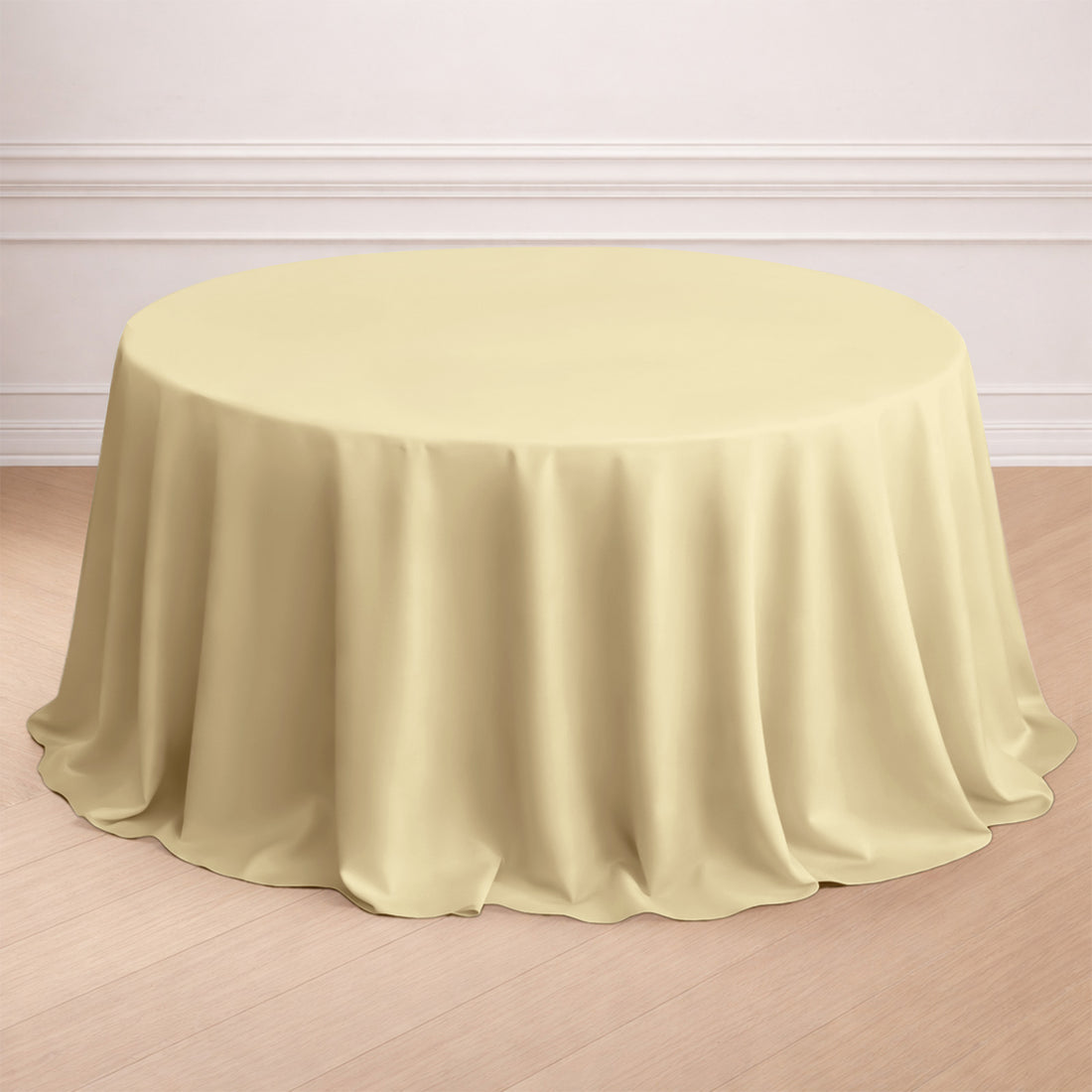 Round yellow tablecloth on a wooden floor.