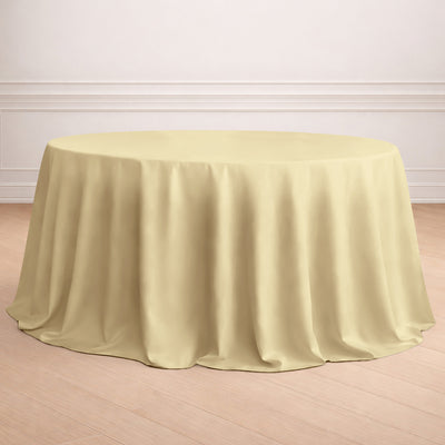 Round yellow tablecloth draped elegantly over a table in a light interior setting.