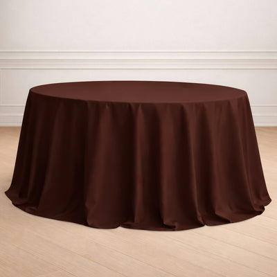 Brown round tablecloth on a wooden floor.