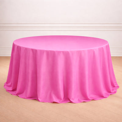 Round pink tablecloth draping over a circular table.