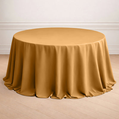 Round gold tablecloth draped elegantly on a table.