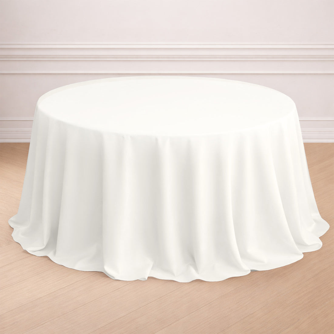 Round white tablecloth draped over a table in a styled setting.