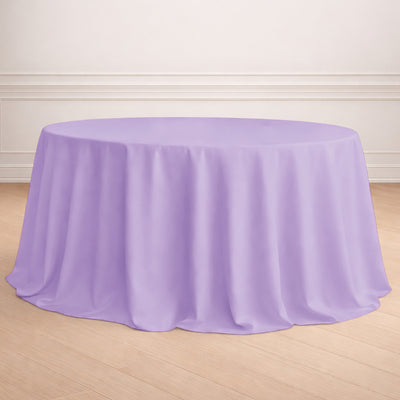 Round lavender tablecloth draped over a table in a staged setting.