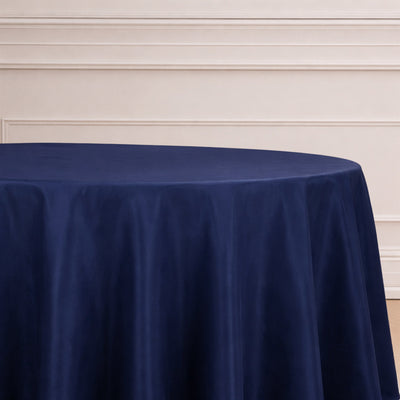 Navy blue round tablecloth on a table with a neutral background.