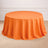 Round orange tablecloth draped elegantly over a table.