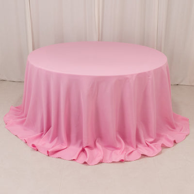 Round pink tablecloth with elegant draping fabric.